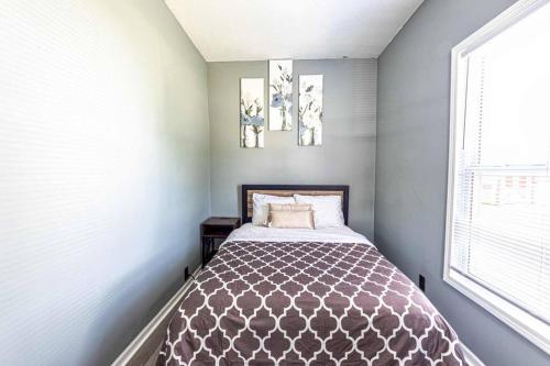 a bedroom with a bed and two pictures on the wall at HOUSE WITH FREE PARKING in Lorain