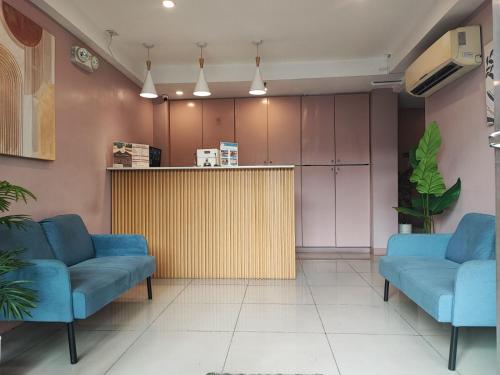 a waiting room with two blue chairs and a counter at Glory Hotel Cubao in Manila