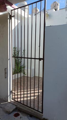 an open gate with a view of a beach behind it at Depa en el corazón de Progreso a 2min del malecón. in Progreso