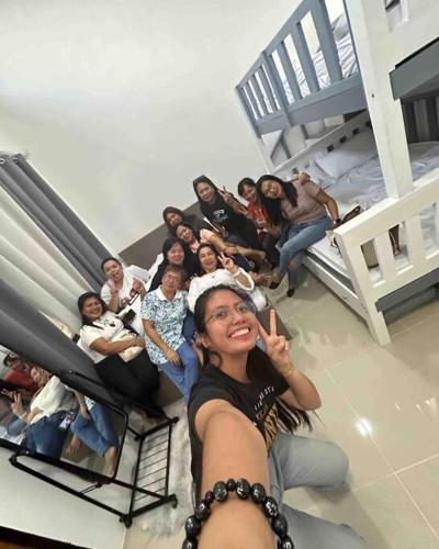 a group of people sitting on the floor of a room at Welcome to Our Farm House in Del Rosario