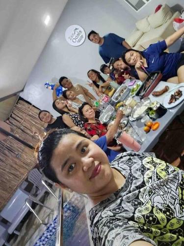a group of people standing around a table in a room at Welcome to Our Farm House in Del Rosario