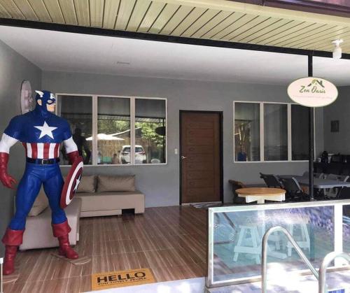 a statue of a superhero standing in a living room at Welcome to Our Farm House in Del Rosario