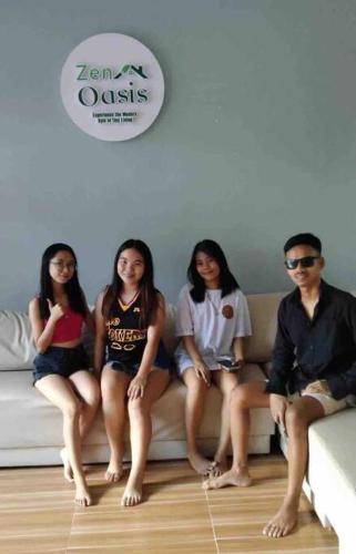 a group of people sitting on a couch at Welcome to Our Farm House in Del Rosario