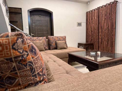 a living room with a couch and a coffee table at Sunrise Residence in Islamabad