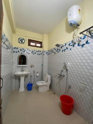 a bathroom with a sink and a toilet and a sink at Ninashi Homestay Wakro 