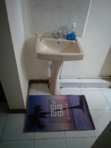 a book sitting on the floor next to a sink at Pritanier in Flic-en-Flac