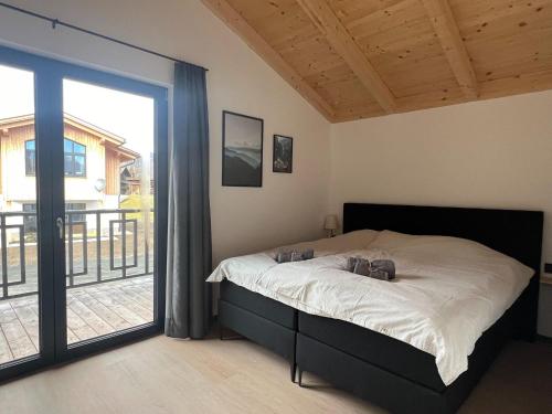 a bedroom with a bed and a large window at Chalet in Hermagor with nice views and sauna in Hermagor