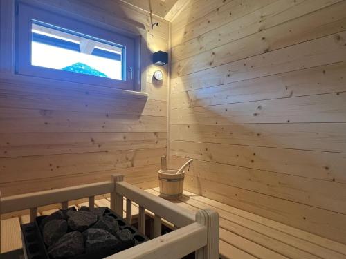 a log cabin with a window and a tub at Chalet in Hermagor with nice views and sauna in Hermagor