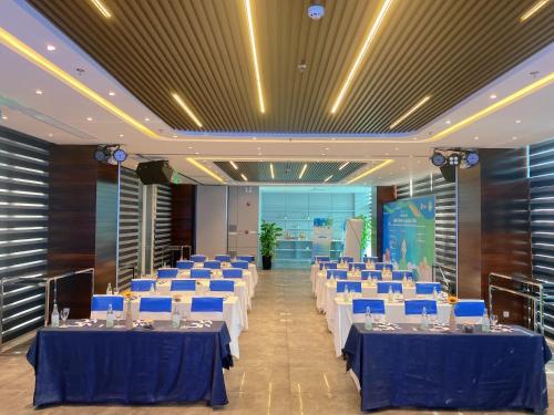 a large banquet hall with blue tables and chairs at Novotel Nha Trang in Nha Trang