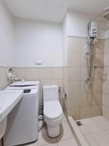 a bathroom with a toilet and a sink and a shower at Azul Condo 2 bedroom Manila in Manila