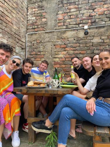 a group of people sitting at a table at Up Hostel in Belgrade