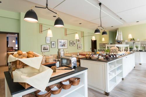 a bakery with a counter with baskets of bread at Hotel Stella Maris in Hamburg