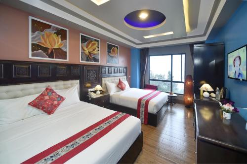 a hotel room with two beds and a window at Sapa Nature View Hotel in Sa Pa