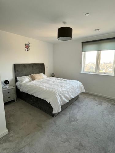 a bedroom with a large bed and a window at One bedroom Apartment in Barking