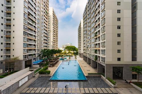 a view of a pool between two tall buildings at Convinia Apartment in Ho Chi Minh City