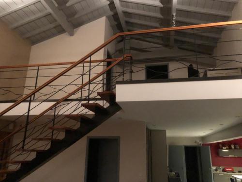 a metal spiral staircase in a building at La tanière in Hasparren