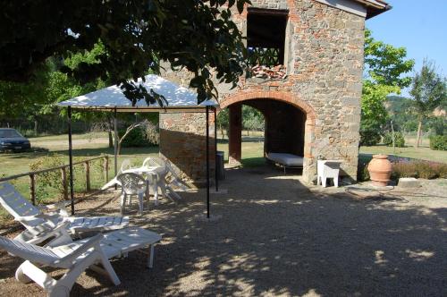 a patio with a table and chairs and a pavilion at Fattoria Antognoni in Reggello