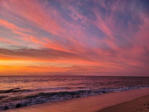 a sunset on a beach with the ocean at 2 Bedroom Villa with Pool & Close to Setangi Beach in Mangsit