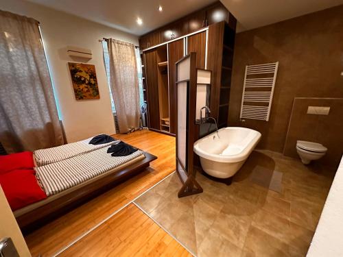 a bathroom with a bed and a tub and a toilet at Castle Stairs Budapest in Budapest