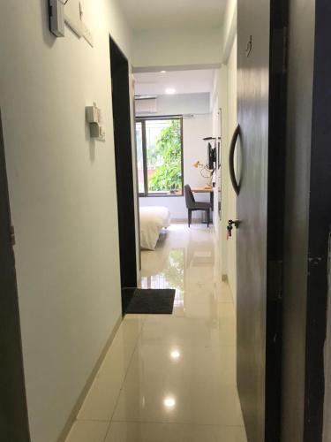 um corredor com uma porta que leva a uma sala de estar em Hooliv 7 Avenues G Block em Pune