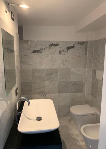 a bathroom with a sink and a toilet at Marble apartment in Prato