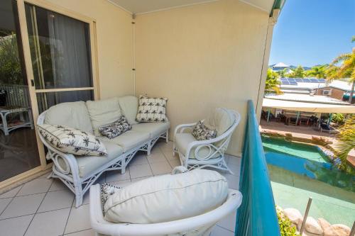a patio with a couch and chairs next to a pool at Unit 10 Sails on Horseshoe in Horseshoe Bay