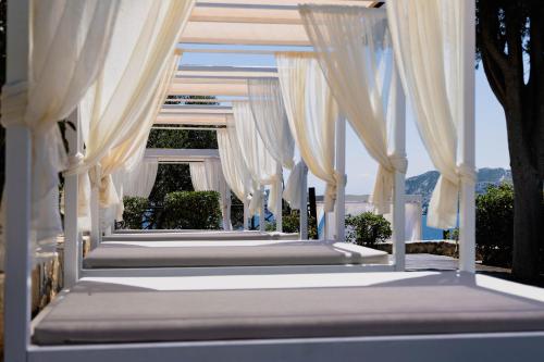 a row of white drapes on a wedding altar at Eva Mare Hotel & Suites - Adults only in Agia Pelagia