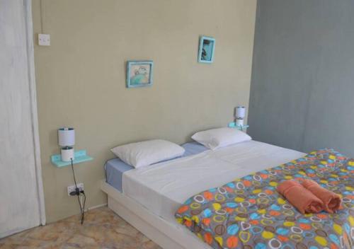 ein kleines Schlafzimmer mit einem Bett in einem Zimmer in der Unterkunft Sea and sand in Pointe d'Esny