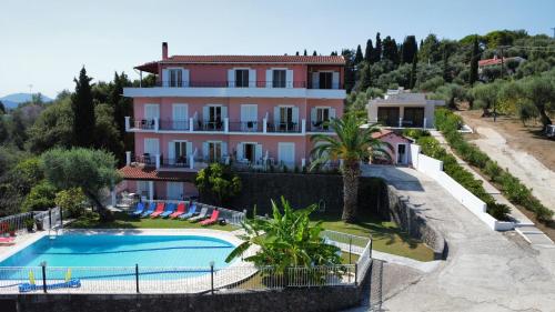 a large house with a swimming pool in front of it at Thomas Apartments in Dassia