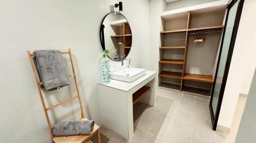 a bathroom with a sink and a mirror at Villa Niu Center Canggu - FattyLion in Canggu