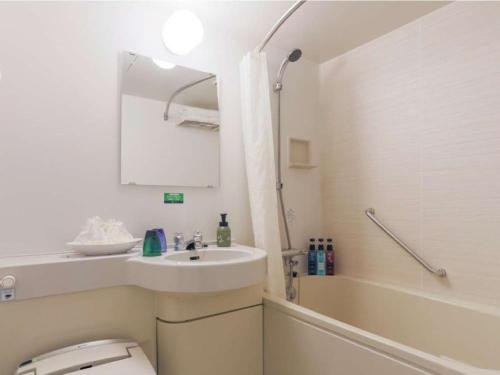 東京的住宿－池袋利索酒店，浴室配有盥洗盆、卫生间和浴缸。
