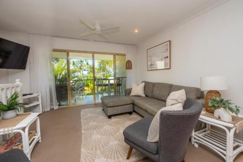 a living room with a couch and a tv at Unit 10 Sails on Horseshoe in Horseshoe Bay