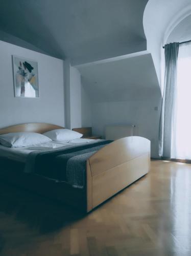 a bedroom with a bed with a wooden floor at Hotel Vienna in Zagreb