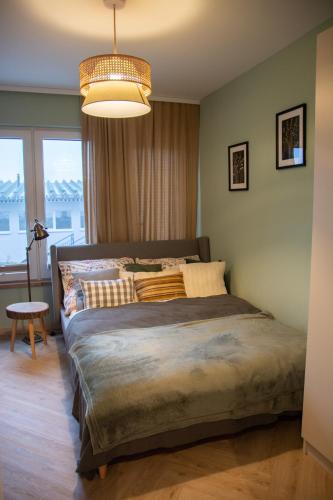 a bedroom with a large bed with a large window at Barbara 76 in Ustroń