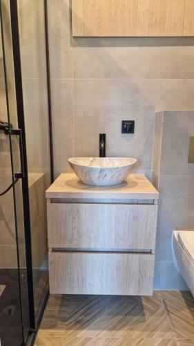 a bathroom with a bowl sink on a counter at Barbara 76 in Ustroń