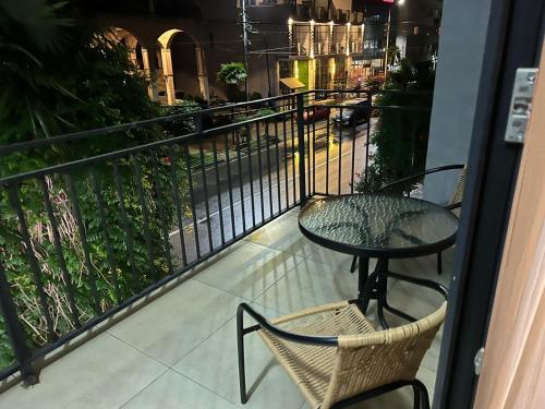a balcony with a table and chairs and a street at Nina two in K'obulet'i