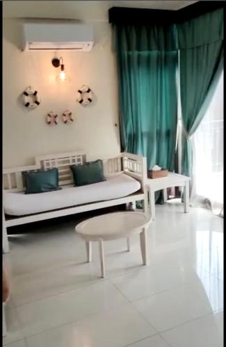 a living room with a couch and a table at Renovated 2 Bedroom Seavilla for 6pax in Pantai Cenang