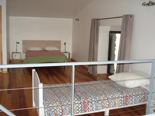 1 dormitorio con 1 cama y balcón en Gîte du Tarbésou, en Régat