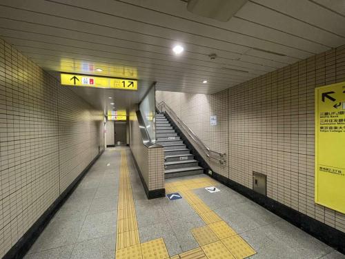 a subway hallway with stairs in a subway station at Hotel Resol Ikebukuro in Tokyo