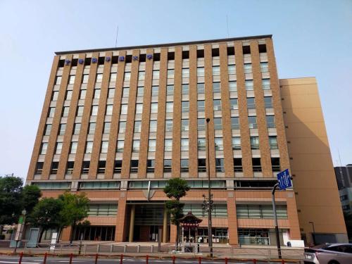 a large brick building on a city street at Hotel Resol Ikebukuro in Tokyo