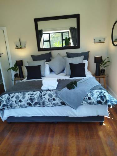a large bed in a bedroom with a mirror at One Three Nine On Roberts in Pietermaritzburg