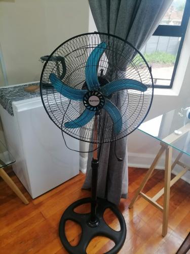 a fan on a stand with a blue ribbon at One Three Nine On Roberts in Pietermaritzburg