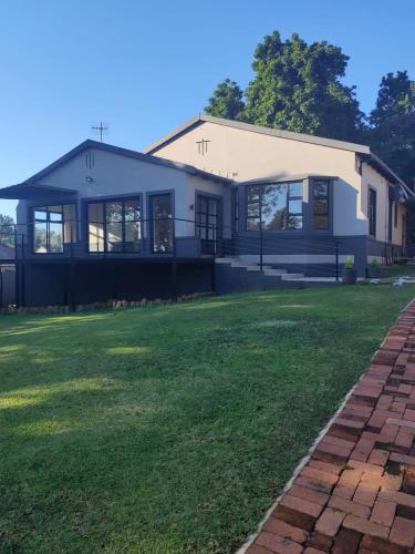 a building with a grass field in front of it at One Three Nine On Roberts in Pietermaritzburg