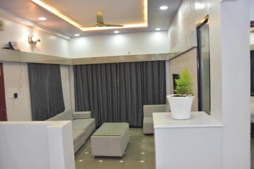 a living room with a couch and a table at Leela Homestay Indore - Tulip - 2 BHK Luxury apartment in Indore