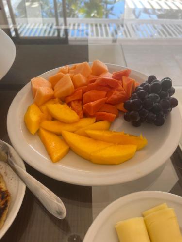 a plate of fruit and vegetables on a table at Maracajau Luxury Home - Villa-Mar-a-Villa in Maxaranguape