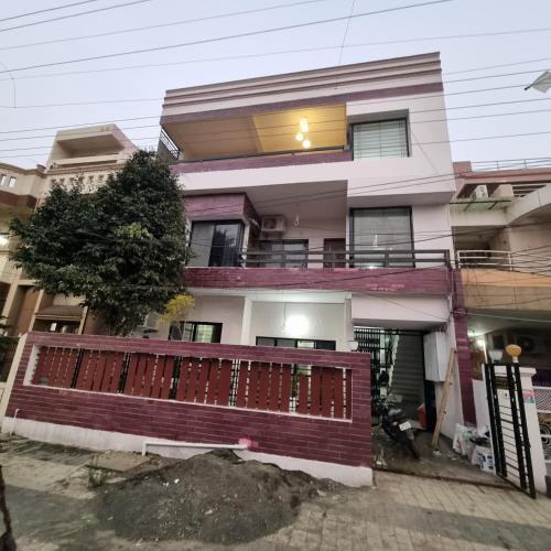 a house with a fence in front of it at Leela Homestay Indore - Tulip - 2 BHK Luxury apartment in Indore