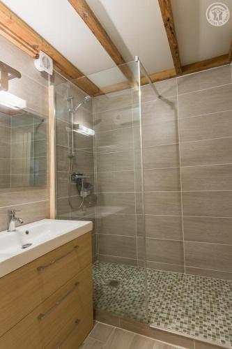 une salle de bain avec un lavabo et une douche en verre dans l'établissement LA DENT PARRACHEE, à Termignon