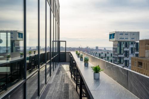 a balcony with potted plants on a building at INNSiDE by Meliá Liverpool in Liverpool