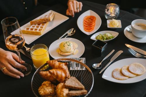 a table topped with plates of breakfast foods and drinks at A-ROSA Hotel Ceres am Meer - Adults Only in Binz