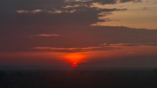 a sunset with the sun in the sky at Amanya 3-Bedroom Hut Amboseli in Amboseli
